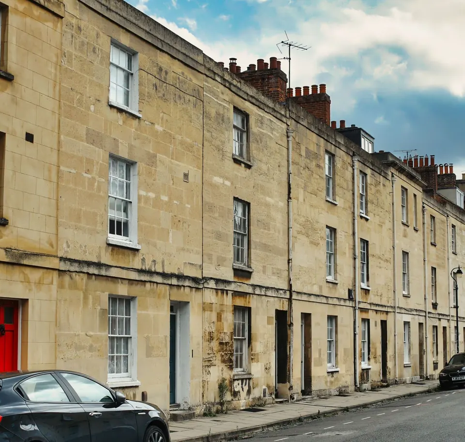 Row of Victorian stone terraced houses on a quiet Oxford street, with a car parked at the kerb